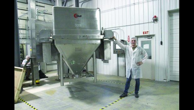 Ben Steuart is shown in front of the new powder mixer/blender currently put in place at the LeRoy facility. This is one of several used pieces of equipment being installed for packaging at this plant.