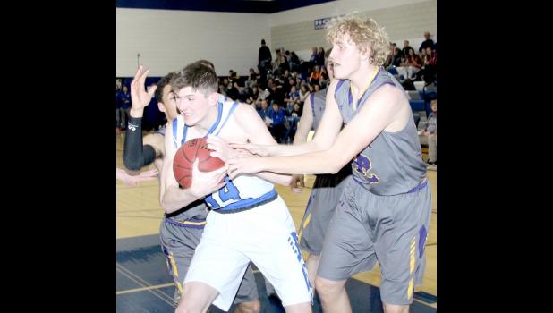 Boston Ferrie grabs a rebound against Oelwein.