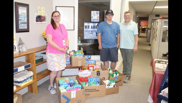 Crestwood Student & Family Caseworker Denise Headington, Crestwood Student Ben Riley and TPD Publisher Dan Evans at the Times Plain Dealer office picking up supplies and donations to bring back to the Cadet Care Closet at Crestwood.