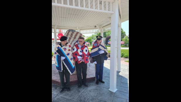 Eric, Dale and Nick Fenske received their Quilts of Valor on Memorial Day at the Freedom Rock in Cresco.