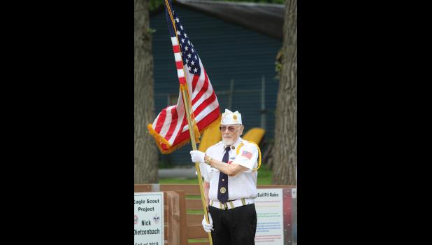 Vice Commander Edward Fontes of the American Legion Post 135 serves as a flag bearer during the event in Cresco.