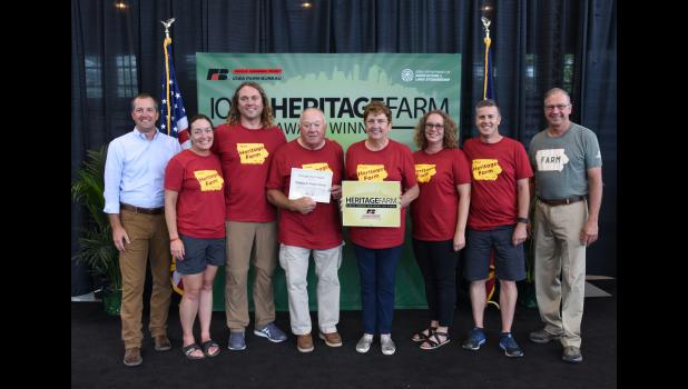 Victor and Sharla Fencl of Protivin were honored for having a Heritage Farm at the Iowa State Fair. They are shown with Iowa Secretary of Ag Mike Naig; son, Tim and Kecia Place-Fencl; Victor and Sharla; daughter, Sarah (Fencl) and Greg Cieciek; and Iowa Farm Bureau Federation President Craig Hill