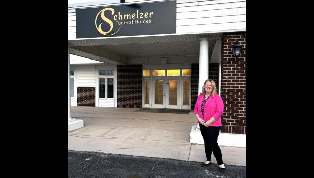 Shannon Schmelzer stands at the entrance of the Cresco Schmelzer Funeral Home facility, located on Hwy. 9.
